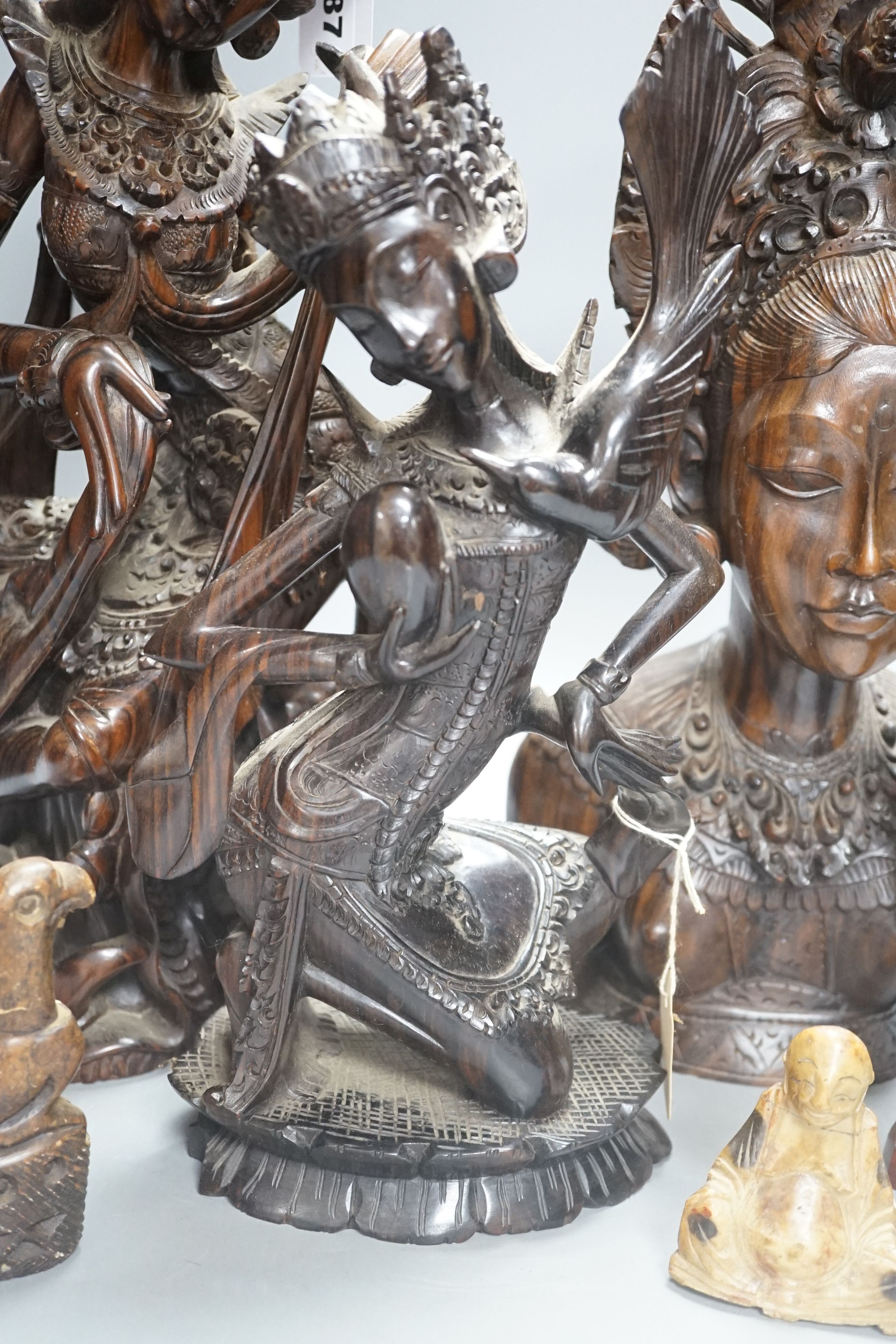 Three Balinese hardwood Macassar Ebony carvings, tallest 44.5 cm, two Chinese soapstone carvings and another